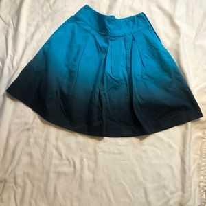 Express A-line pleated skirt featuring a blue and black ombre design, Size 2